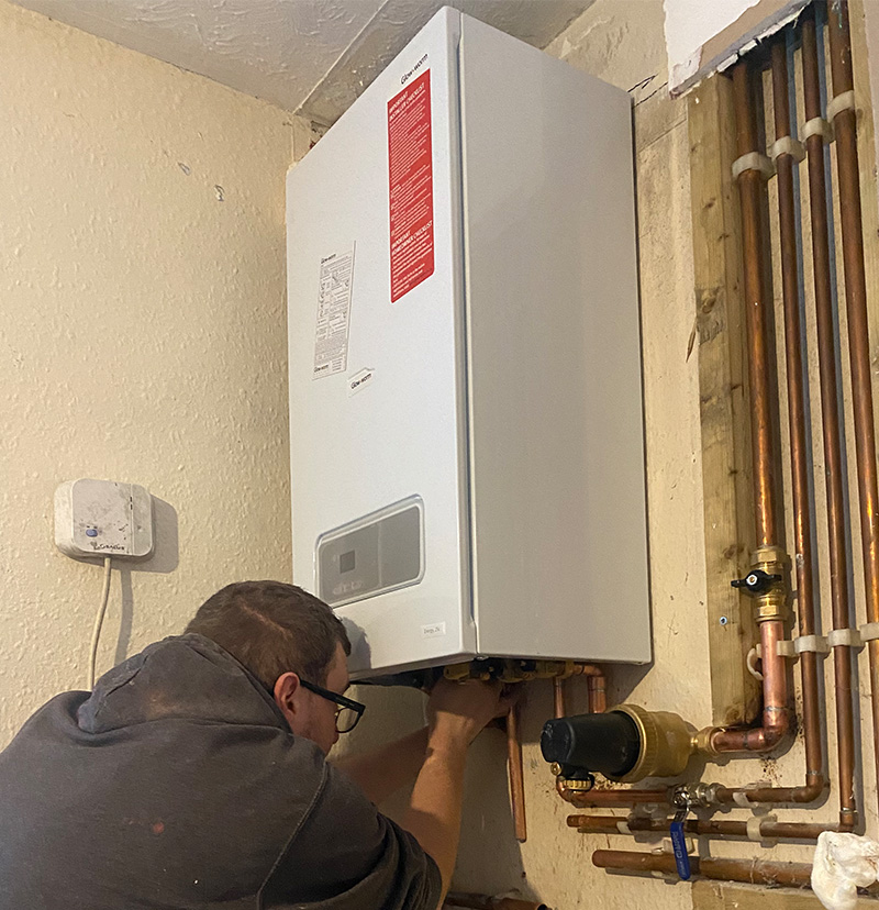 Gas Safe engineer commissioning a newly fitted Glow-worm boiler