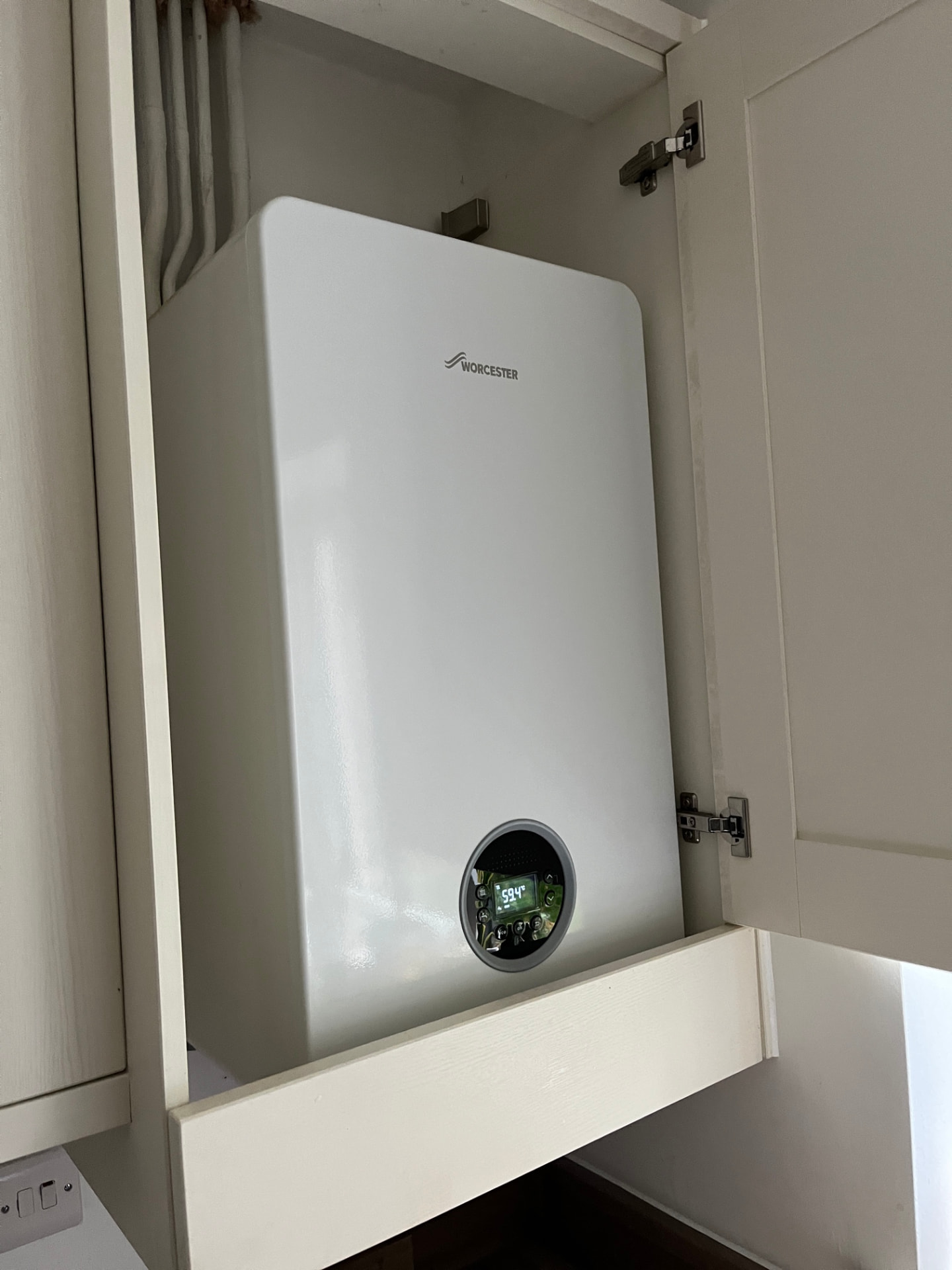 New Worcester combi boiler fitted inside a kitchen cupboard